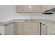 Kitchen featuring wood cabinets, a double sink, and ample storage space at 304 Orland St # 47, Las Vegas, NV 89107