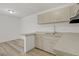 Bright kitchen featuring wood cabinets, laminate flooring, and an open layout at 304 Orland St # 47, Las Vegas, NV 89107