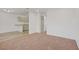 Open living space with combined living and kitchen areas, neutral tones, and carpeted living room at 304 Orland St # 47, Las Vegas, NV 89107