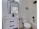 Updated bathroom boasts modern vanity with drawers, framed mirror, tub and toilet at 3040 Carroll St, North Las Vegas, NV 89030