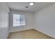 This bedroom features wood floors, a window with blinds, and a sliding door closet at 3040 Carroll St, North Las Vegas, NV 89030