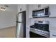 Modern kitchen featuring stainless steel appliances, quartz countertops, and plenty of cabinet space at 3040 Carroll St, North Las Vegas, NV 89030