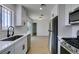Well-lit kitchen with stainless steel appliances, white cabinets, and a modern faucet at 3040 Carroll St, North Las Vegas, NV 89030