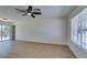 Bright living room featuring wood floors, a ceiling fan, and a large window for ample natural light at 3040 Carroll St, North Las Vegas, NV 89030