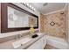 Bathroom featuring a double vanity, tile backsplash, large mirror, and soaking tub at 3091 Via Del Corso, Henderson, NV 89052