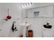 Modern powder room with pedestal sink, decorative mirror, and stylish accents at 3091 Via Del Corso, Henderson, NV 89052
