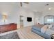 Spacious bedroom featuring light hardwood floors, an entertainment center, and mountain views at 3091 Via Del Corso, Henderson, NV 89052