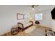 Cozy bedroom with modern decor, a comfortable sofa, a ceiling fan, and a tv at 3091 Via Del Corso, Henderson, NV 89052