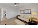 Cozy bedroom with modern decor, a comfortable sofa, a ceiling fan, and a closet at 3091 Via Del Corso, Henderson, NV 89052