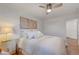 Comfortable bedroom with soft lighting, ceiling fan, and large bed with cozy linens at 3091 Via Del Corso, Henderson, NV 89052