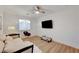 Cozy bedroom with modern decor, a comfortable sofa, a ceiling fan, and a tv at 3091 Via Del Corso, Henderson, NV 89052