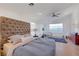 Bright bedroom with large window, tufted headboard, and light hardwood floors at 3091 Via Del Corso, Henderson, NV 89052