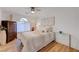 Bright bedroom with a ceiling fan, a large window, and a dresser and glass end table at 3091 Via Del Corso, Henderson, NV 89052