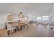 Open-concept dining area with stylish table and chairs, bright lighting, and access to other living spaces at 3091 Via Del Corso, Henderson, NV 89052