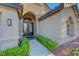 Stunning home featuring arched entryway with ornate double doors and manicured landscaping at 3091 Via Del Corso, Henderson, NV 89052