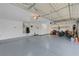 Spacious garage with epoxy flooring, ample storage cabinets, water heater and door to the interior at 3091 Via Del Corso, Henderson, NV 89052