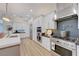 Stylish kitchen features stainless appliances, white cabinetry, and a professional range hood at 3091 Via Del Corso, Henderson, NV 89052