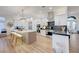Bright, open kitchen with white cabinets, stainless appliances, and large center island at 3091 Via Del Corso, Henderson, NV 89052
