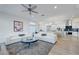 Spacious living area flows into kitchen, featuring modern decor and ample natural light at 3091 Via Del Corso, Henderson, NV 89052