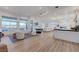 Expansive living area with picturesque views, modern furnishings, and seamless flow to the kitchen at 3091 Via Del Corso, Henderson, NV 89052