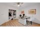 Bright office featuring a clear desk, white cushioned chair, a ceiling fan and an organized closet at 3091 Via Del Corso, Henderson, NV 89052