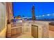 Outdoor kitchen featuring a built-in grill, mini-fridge, and stone countertop at 3091 Via Del Corso, Henderson, NV 89052