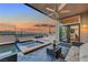 Inviting covered patio featuring a jacuzzi with views, modern furniture, and a ceiling fan at 3091 Via Del Corso, Henderson, NV 89052