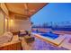 Stylish covered patio featuring a jacuzzi, outdoor furniture, and a ceiling fan with scenic views at 3091 Via Del Corso, Henderson, NV 89052