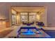 Relaxing outdoor space showcasing a pool, jacuzzi, modern seating, covered patio and exterior lighting at 3091 Via Del Corso, Henderson, NV 89052