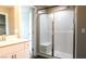 Bathroom featuring shower with glass door, bench, and light wood cabinets at 3767 Paseo De Paz Ave, Las Vegas, NV 89115