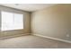 Bedroom featuring neutral carpet, walls, and a large window at 3767 Paseo De Paz Ave, Las Vegas, NV 89115