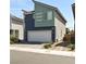 Two-story home with two-car garage, modern window design, and low-maintenance landscaping at 3767 Paseo De Paz Ave, Las Vegas, NV 89115