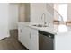 Modern kitchen with stainless steel dishwasher, double sink, faucet, and quartz countertops at 3767 Paseo De Paz Ave, Las Vegas, NV 89115