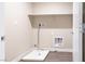 A dedicated laundry room with modern wood-look flooring and essential appliance hookups at 3767 Paseo De Paz Ave, Las Vegas, NV 89115