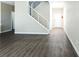 Open-concept living area with hardwood floors, white staircase, and natural light at 3767 Paseo De Paz Ave, Las Vegas, NV 89115