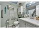 Well-lit bathroom with a gray vanity, white toilet, updated fixtures, and accessible features for convenience at 3879 Atlantis St, Las Vegas, NV 89121