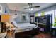 Comfortable bedroom features hardwood floors, ample natural light, and a ceiling fan for added comfort at 3879 Atlantis St, Las Vegas, NV 89121