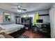 Comfortable bedroom features hardwood floors, ample natural light, and a ceiling fan for added comfort at 3879 Atlantis St, Las Vegas, NV 89121