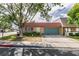 Charming single-story home featuring a red tile roof and lush landscaping in a tranquil neighborhood at 3879 Atlantis St, Las Vegas, NV 89121