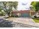 Charming single-story home featuring a red tile roof and lush landscaping in a tranquil neighborhood at 3879 Atlantis St, Las Vegas, NV 89121