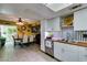 Open concept kitchen showcasing white cabinets, butcher block countertops, stainless steel appliances, and tiled flooring at 3879 Atlantis St, Las Vegas, NV 89121