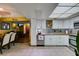 Open concept kitchen showcasing white cabinets, butcher block countertops, stainless steel appliances, and tiled flooring at 3879 Atlantis St, Las Vegas, NV 89121