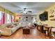 Inviting living room with hardwood floors, ceiling fan and open access to the dining area at 3879 Atlantis St, Las Vegas, NV 89121