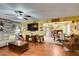 Inviting living room with hardwood floors, ceiling fan and open access to the dining area at 3879 Atlantis St, Las Vegas, NV 89121
