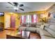 Inviting living room with hardwood floors, ceiling fan and a unique purple front door at 3879 Atlantis St, Las Vegas, NV 89121