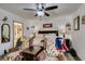 Comfortable main bedroom with decorations, including two chairs and a ceiling fan at 3879 Atlantis St, Las Vegas, NV 89121