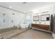 Modern bathroom featuring a walk-in shower, soaking tub, double vanity, and sleek, contemporary fixtures at 3934 Sangre De Cristo Ave, Las Vegas, NV 89118