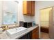 Bathroom featuring a white sink, granite countertops, wooden cabinets, and a view to the walk-in closet at 3934 Sangre De Cristo Ave, Las Vegas, NV 89118