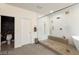 Luxurious bathroom with a glass shower, rain shower head, and pebble flooring at 3934 Sangre De Cristo Ave, Las Vegas, NV 89118
