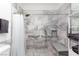 Beautiful bathroom with modern gray marble tile in the shower, shower bench, and a handheld shower head at 3934 Sangre De Cristo Ave, Las Vegas, NV 89118